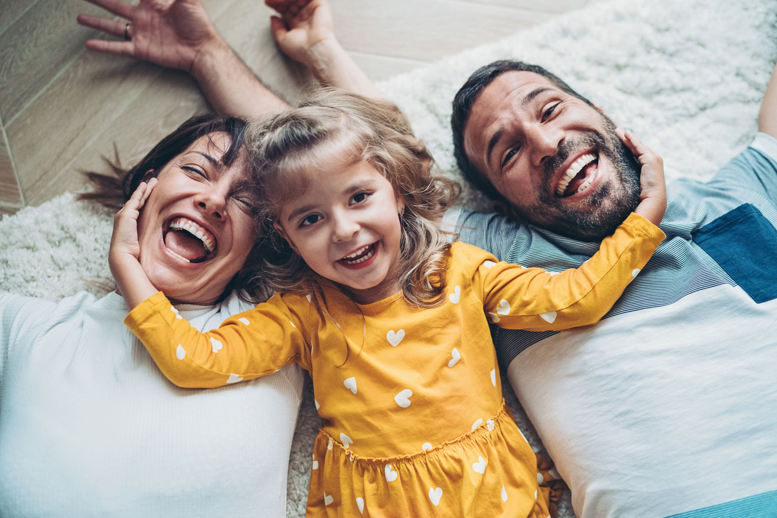 Fun portrait of two parents and a small girl