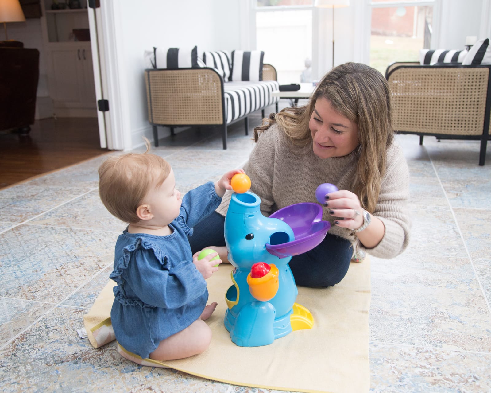 Marie and a one year old engaging with an Elefun ball toy